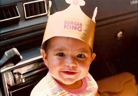 A baby wearing a paper Burger King crown