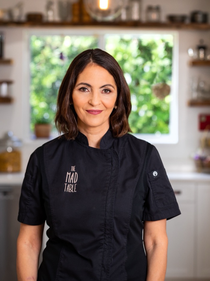 Chef Patty Morrell-Ruiz in a black chef coat in a bright kitchen