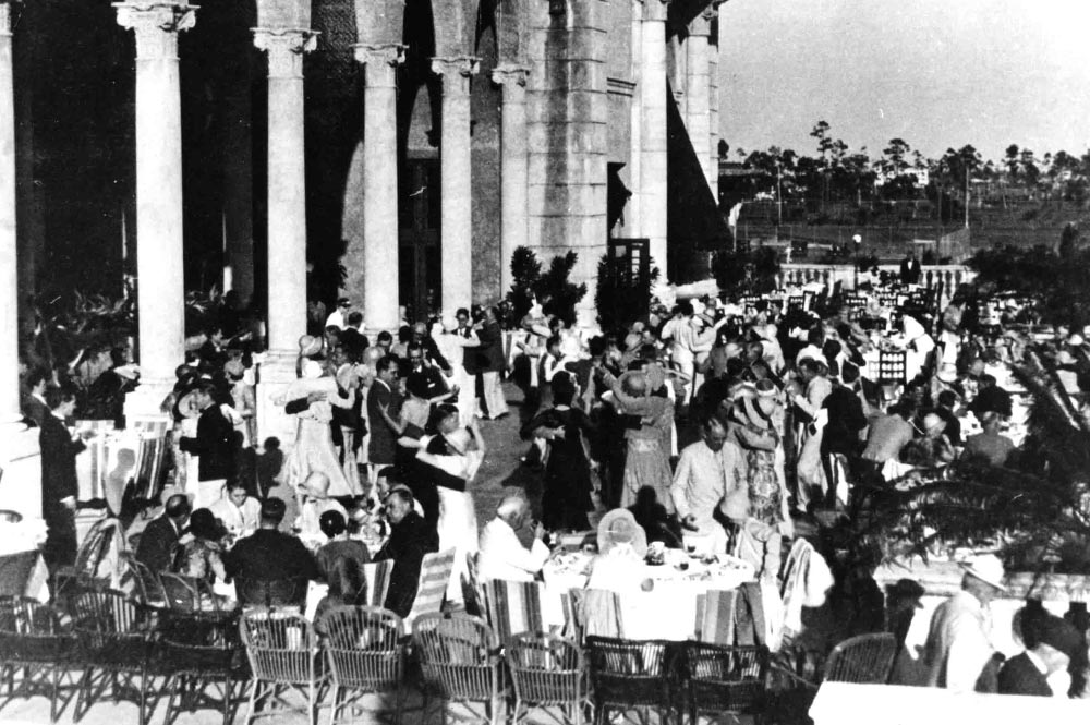 Couples dancing and guests at tables during a tea dance on the Biltmore Hotel terrace in the 1930s